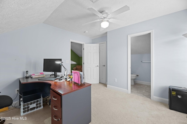 carpeted home office featuring vaulted ceiling, ceiling fan, and a textured ceiling