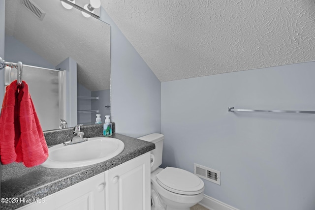 bathroom featuring walk in shower, lofted ceiling, toilet, a textured ceiling, and vanity