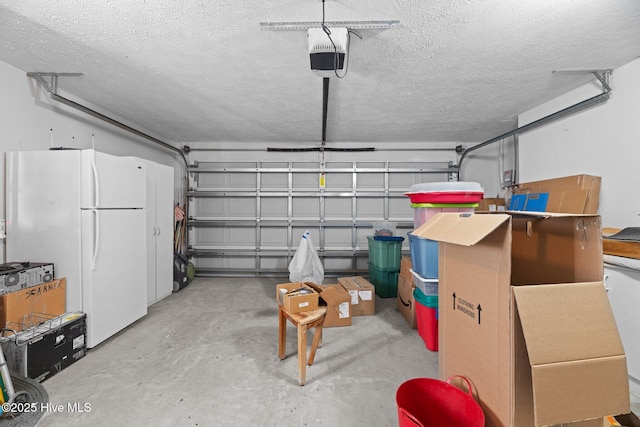 garage with white refrigerator and a garage door opener