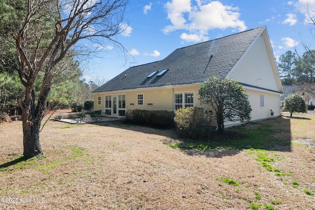 rear view of house featuring french doors