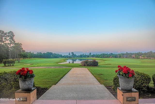 surrounding community with a lawn and a water view