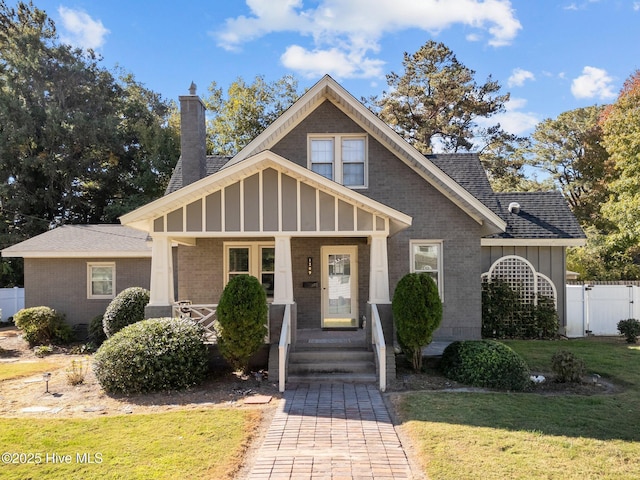 view of front of property with a front yard and covered porch