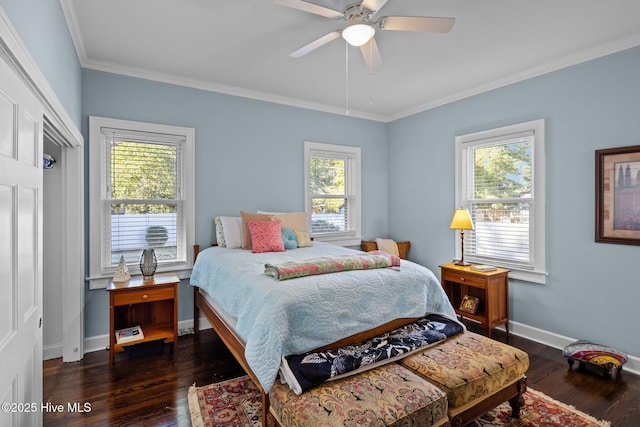 bedroom with dark wood-type flooring, ornamental molding, and ceiling fan