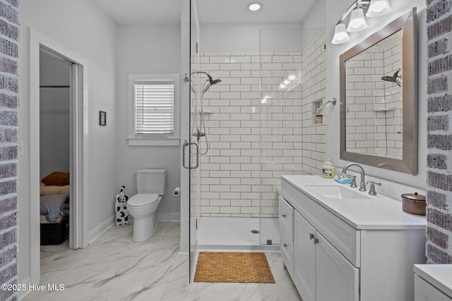 bathroom with vanity, toilet, and a shower with shower door