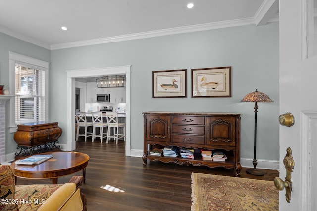 living area with dark hardwood / wood-style flooring and crown molding