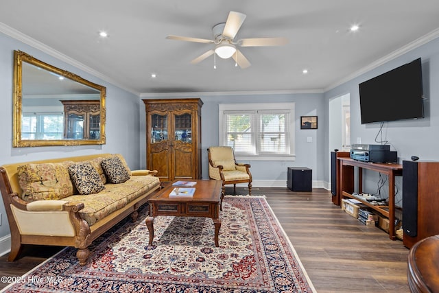 living room with hardwood / wood-style flooring, ceiling fan, and ornamental molding