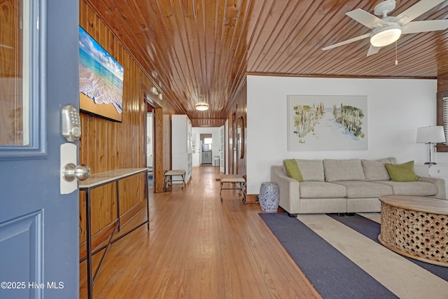 living room featuring hardwood / wood-style floors, ornamental molding, wooden ceiling, and ceiling fan