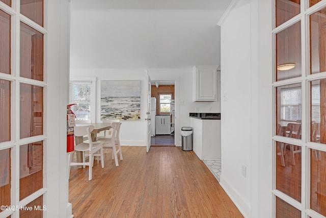 kitchen with plenty of natural light, light wood-type flooring, and white cabinets