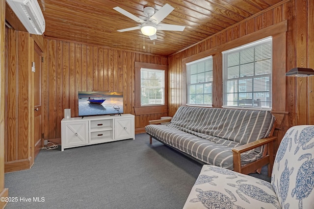 carpeted living room with ceiling fan, wood walls, a wall unit AC, and wooden ceiling