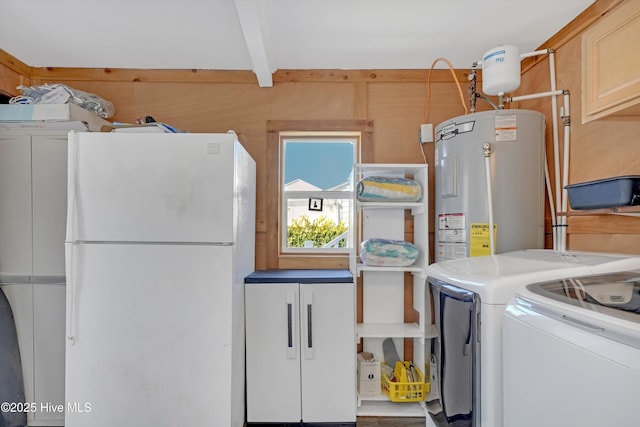 laundry area with washer and dryer, cabinets, and water heater