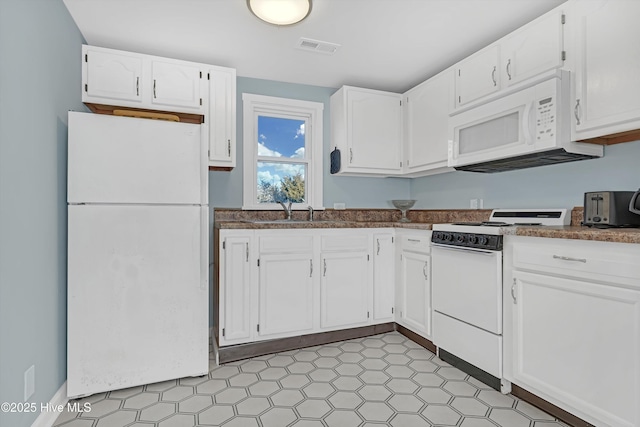 kitchen featuring sink, white appliances, and white cabinets