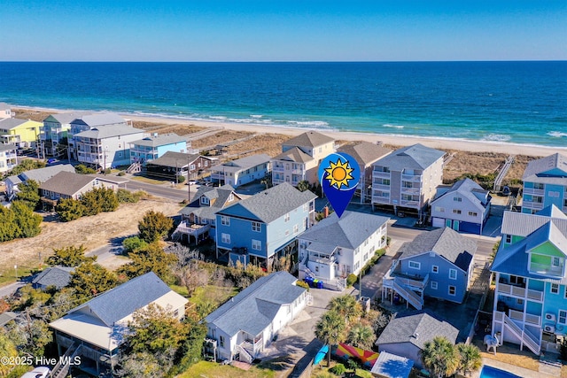 drone / aerial view featuring a beach view and a water view