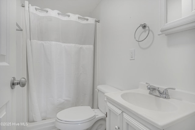 bathroom with vanity, curtained shower, and toilet