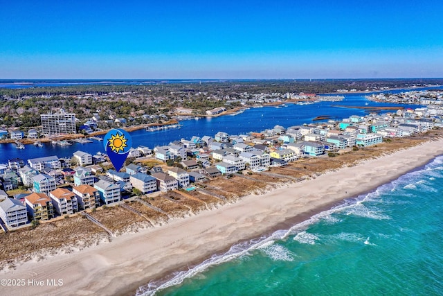 drone / aerial view featuring a water view and a beach view