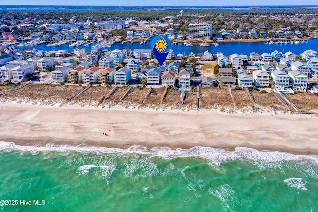 bird's eye view with a water view and a beach view