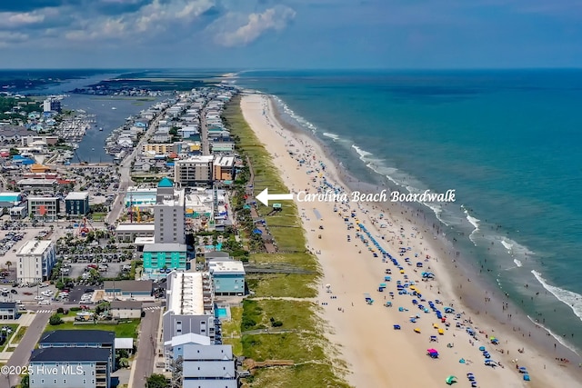 birds eye view of property featuring a water view and a beach view