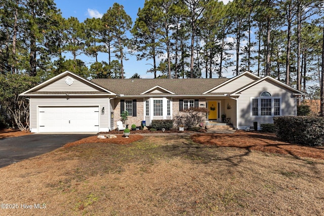 ranch-style house featuring a garage and a front yard