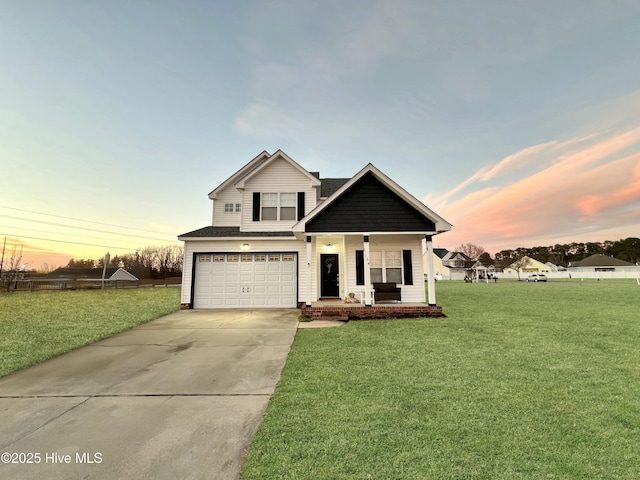 view of front of property featuring a porch, a yard, and a garage