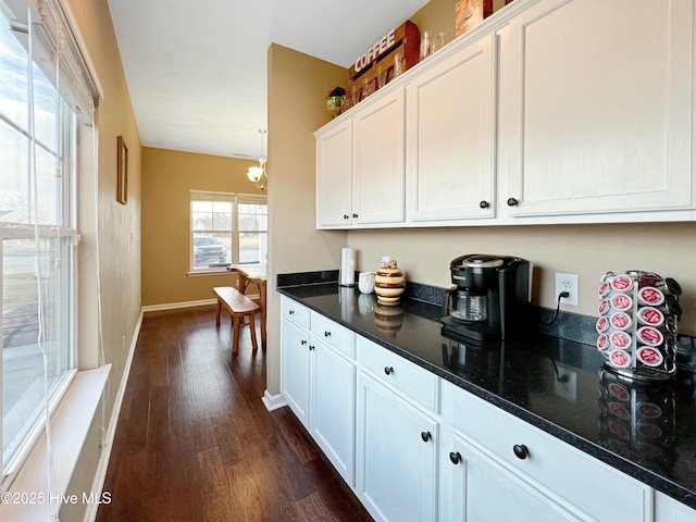 kitchen with white cabinetry and dark hardwood / wood-style flooring