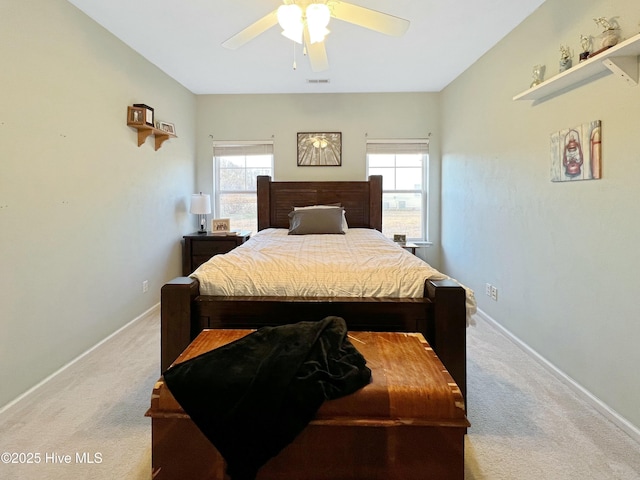 carpeted bedroom featuring multiple windows and ceiling fan