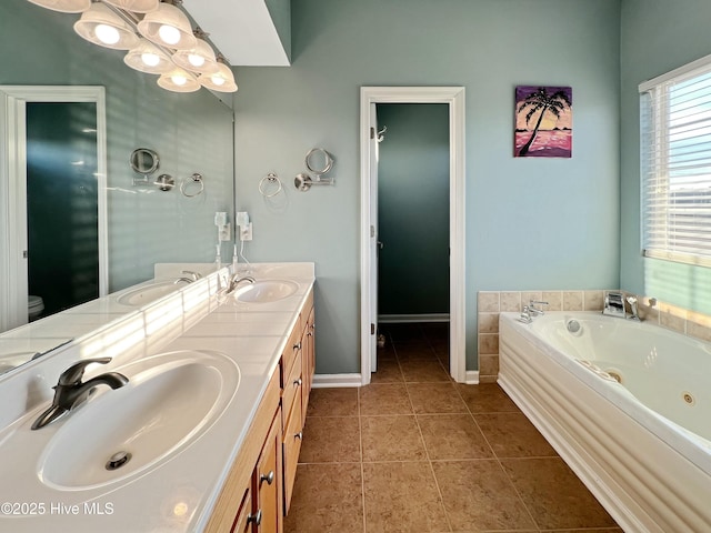 bathroom with toilet, vanity, a bath, and tile patterned flooring