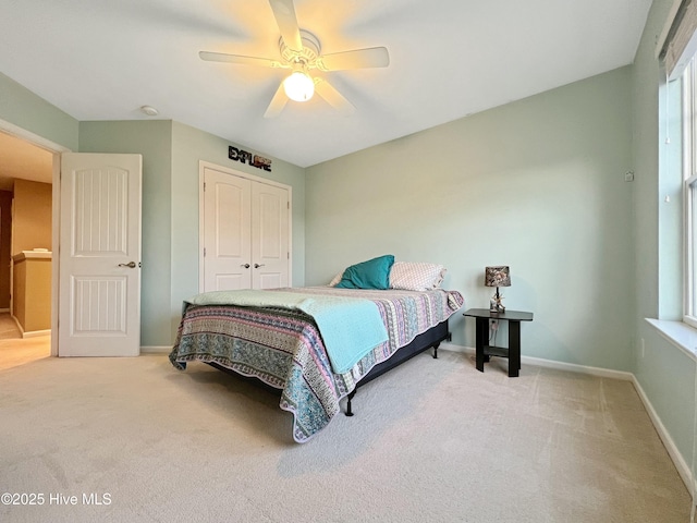 bedroom featuring light carpet, a closet, and ceiling fan