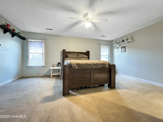 carpeted bedroom featuring ceiling fan and multiple windows