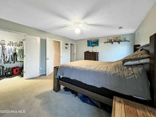 bedroom featuring light carpet, ceiling fan, and a closet