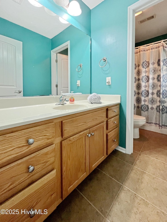 bathroom featuring vanity, ceiling fan, tile patterned floors, and toilet