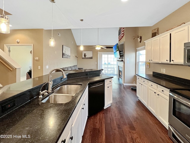 kitchen featuring sink, hanging light fixtures, dark hardwood / wood-style floors, stainless steel appliances, and white cabinets