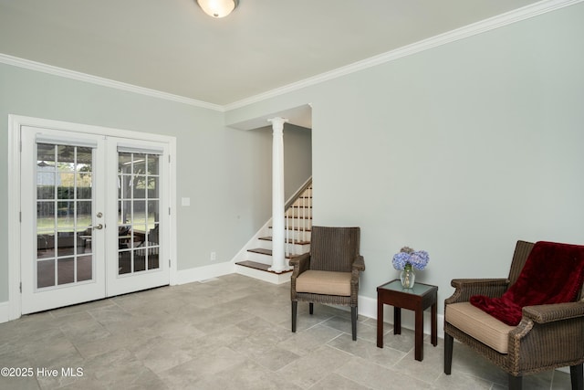 living area with french doors, crown molding, and decorative columns