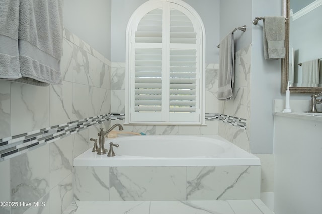 bathroom with a relaxing tiled tub