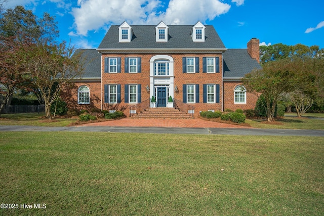 colonial home with a front lawn