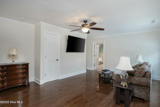 sitting room with ceiling fan, ornamental molding, and dark hardwood / wood-style floors