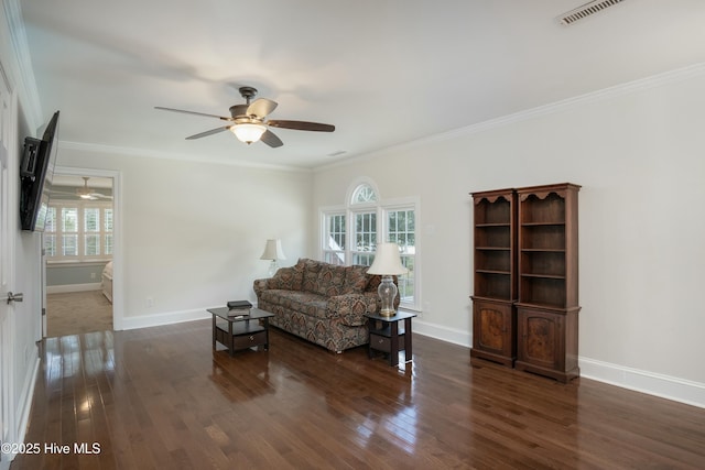 living room with dark wood-type flooring, ornamental molding, a healthy amount of sunlight, and ceiling fan