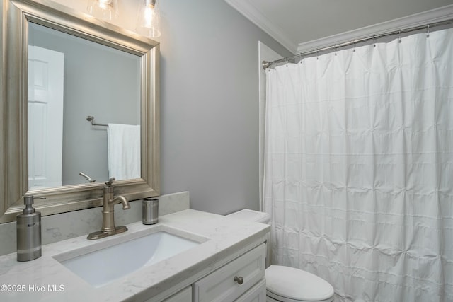 bathroom with walk in shower, ornamental molding, vanity, and toilet