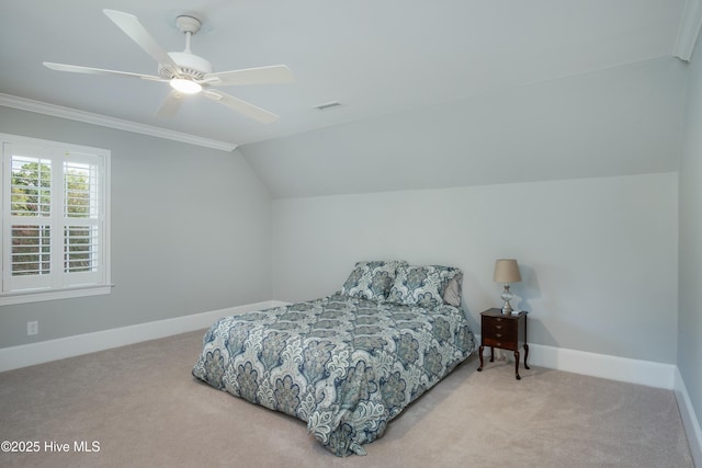 bedroom featuring vaulted ceiling, light carpet, ceiling fan, and crown molding