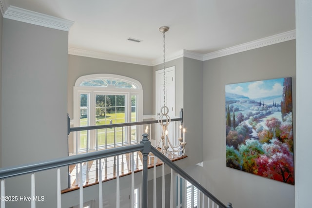 hall featuring a notable chandelier and crown molding