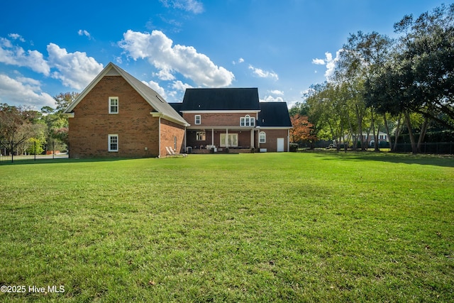 rear view of property featuring a yard