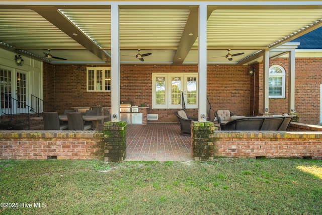 view of patio featuring area for grilling and ceiling fan