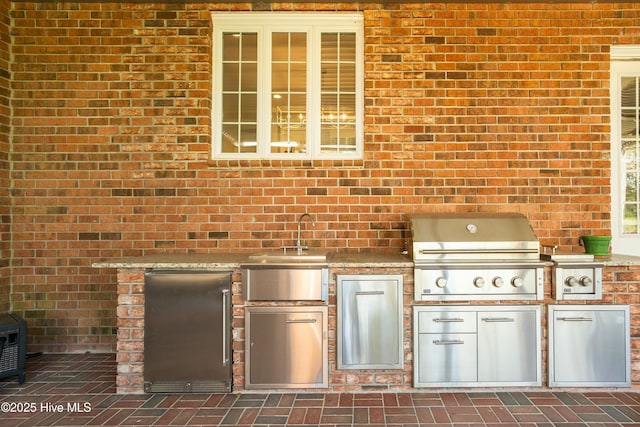 view of patio with area for grilling and sink