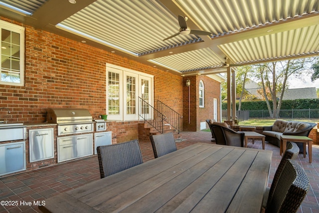 view of patio featuring area for grilling, grilling area, and ceiling fan