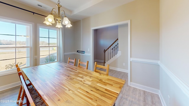 dining space with an inviting chandelier and hardwood / wood-style flooring