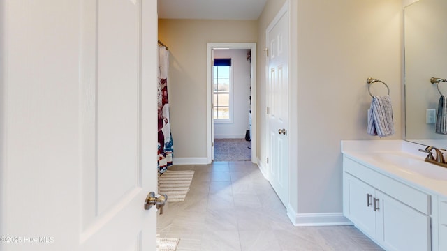 full bath featuring tile patterned flooring, baseboards, vanity, and curtained shower