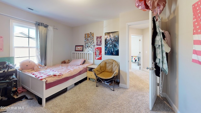 bedroom featuring light carpet