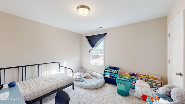 carpeted bedroom featuring visible vents