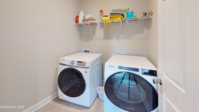 laundry room featuring light tile patterned floors and independent washer and dryer