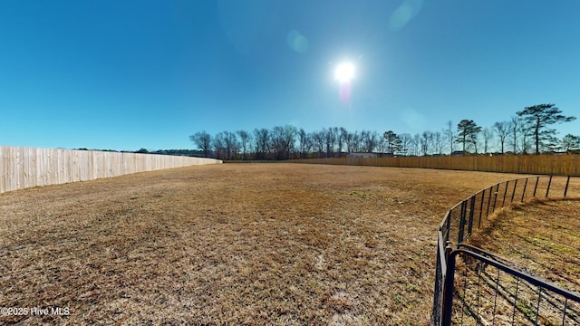 view of yard with a rural view