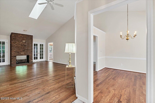 6 Elmhurst Pl, Pinehurst, NC 28374 - unfurnished living room featuring high vaulted ceiling, a chandelier, wood finished floors, ceiling fan, and a fireplace