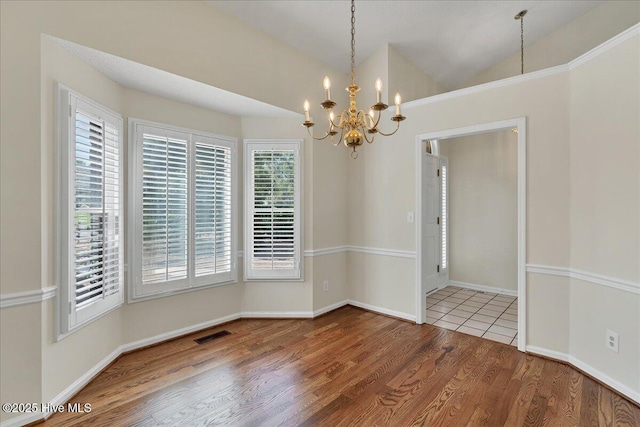 6 Elmhurst Pl, Pinehurst, NC 28374 - unfurnished dining area featuring a chandelier, plenty of natural light, wood finished floors, and lofted ceiling